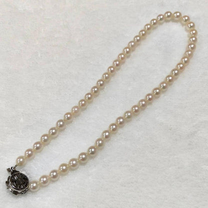 Akoya pearl necklace with 7mm round pearls and silver marking, 36cm length, displayed on white background
