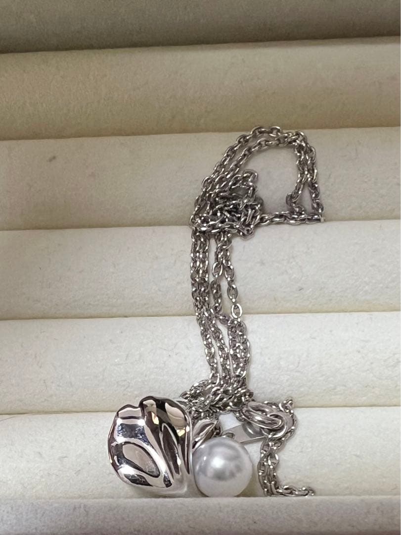 Mikimoto Silver Vendome Petal Necklace featuring a single pearl on silver petals, displayed on white background