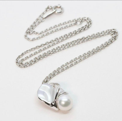 Mikimoto Silver Vendome Petal Necklace featuring a single pearl on silver petals, displayed on white background