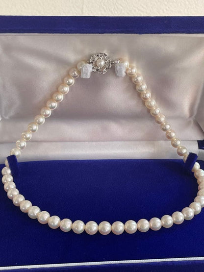 Akoya pearl necklace with 7.5-8mm white pink pearls and silver clasp displayed on white background