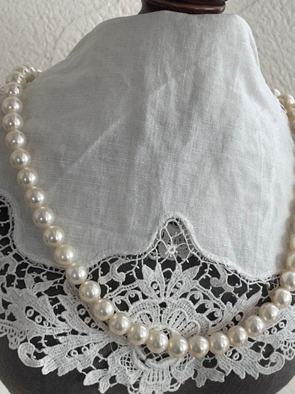 Akoya pearl necklace with 7.5-8mm white pink pearls and silver clasp displayed on white background