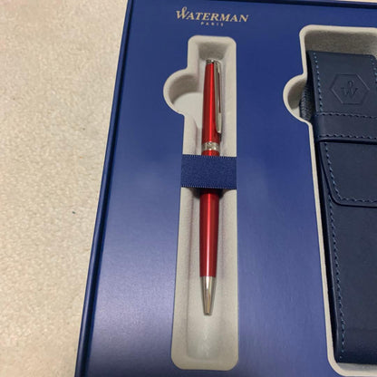 Unused Waterman red ballpoint pen paired with a blue pen case