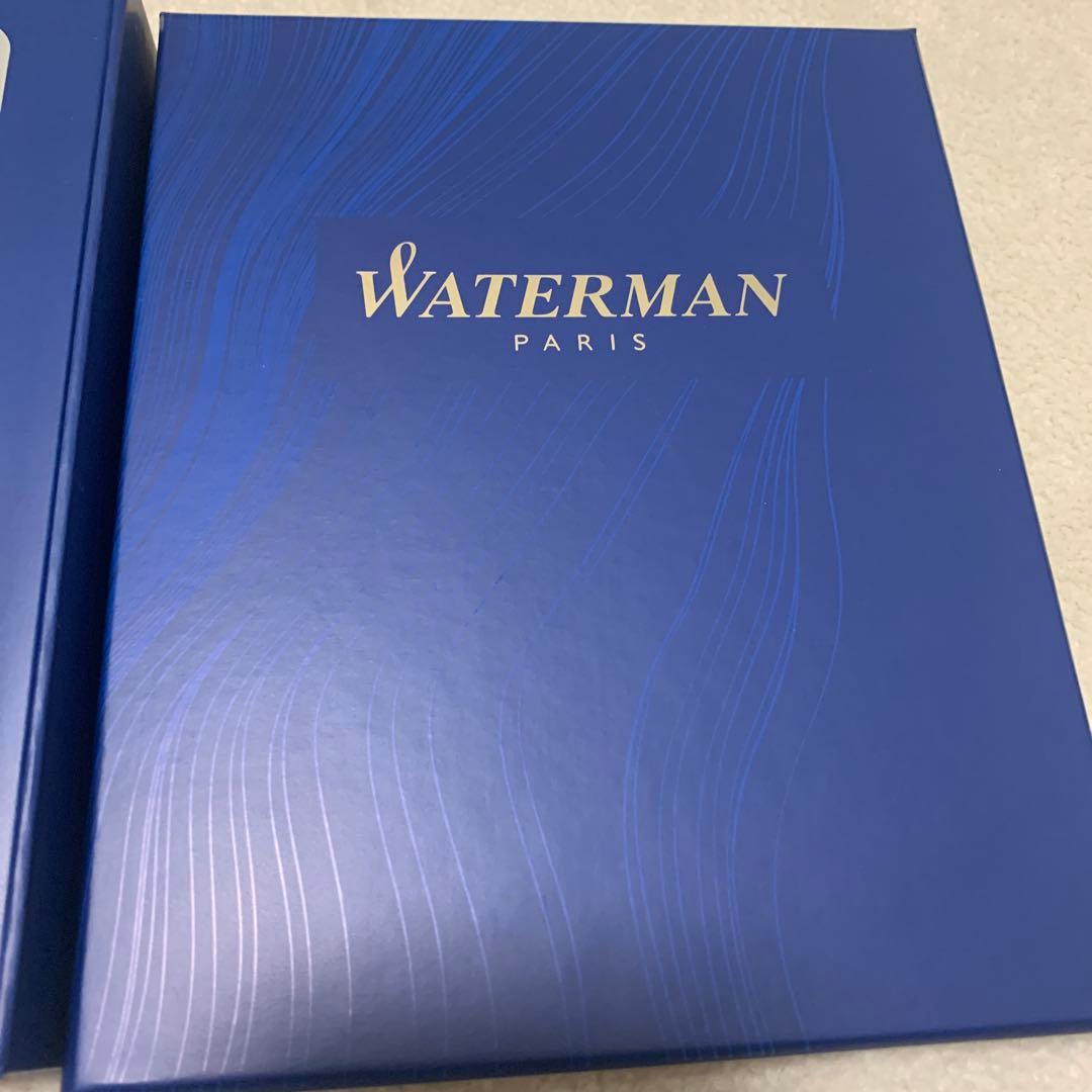 Unused Waterman red ballpoint pen paired with a blue pen case