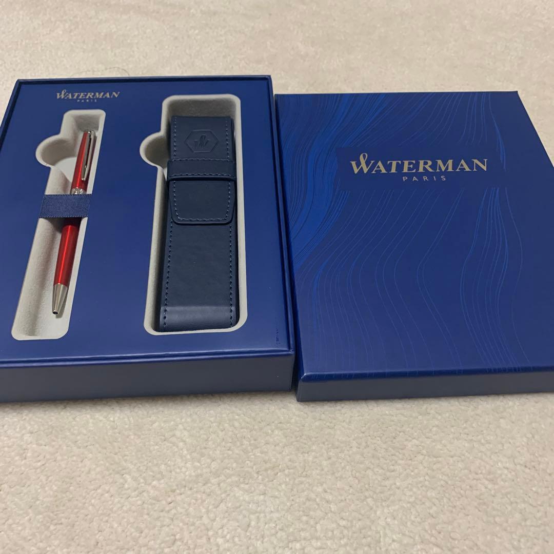 Unused Waterman red ballpoint pen paired with a blue pen case