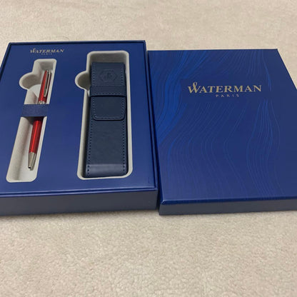 Unused Waterman red ballpoint pen paired with a blue pen case