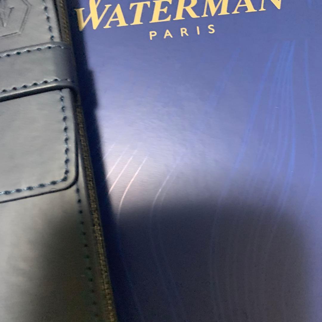 Unused Waterman red ballpoint pen paired with a blue pen case