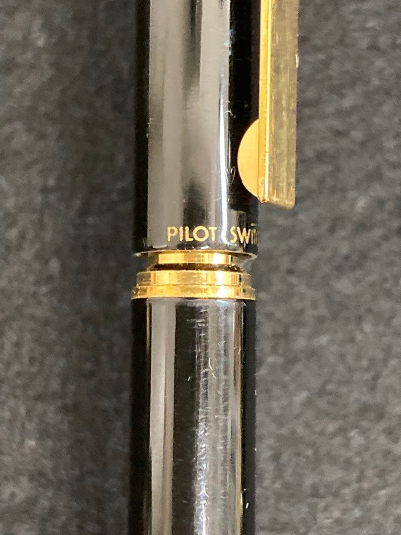 Two PILOT SWITCH black fountain pens with gold-colored accents and plastic bodies displayed side by side