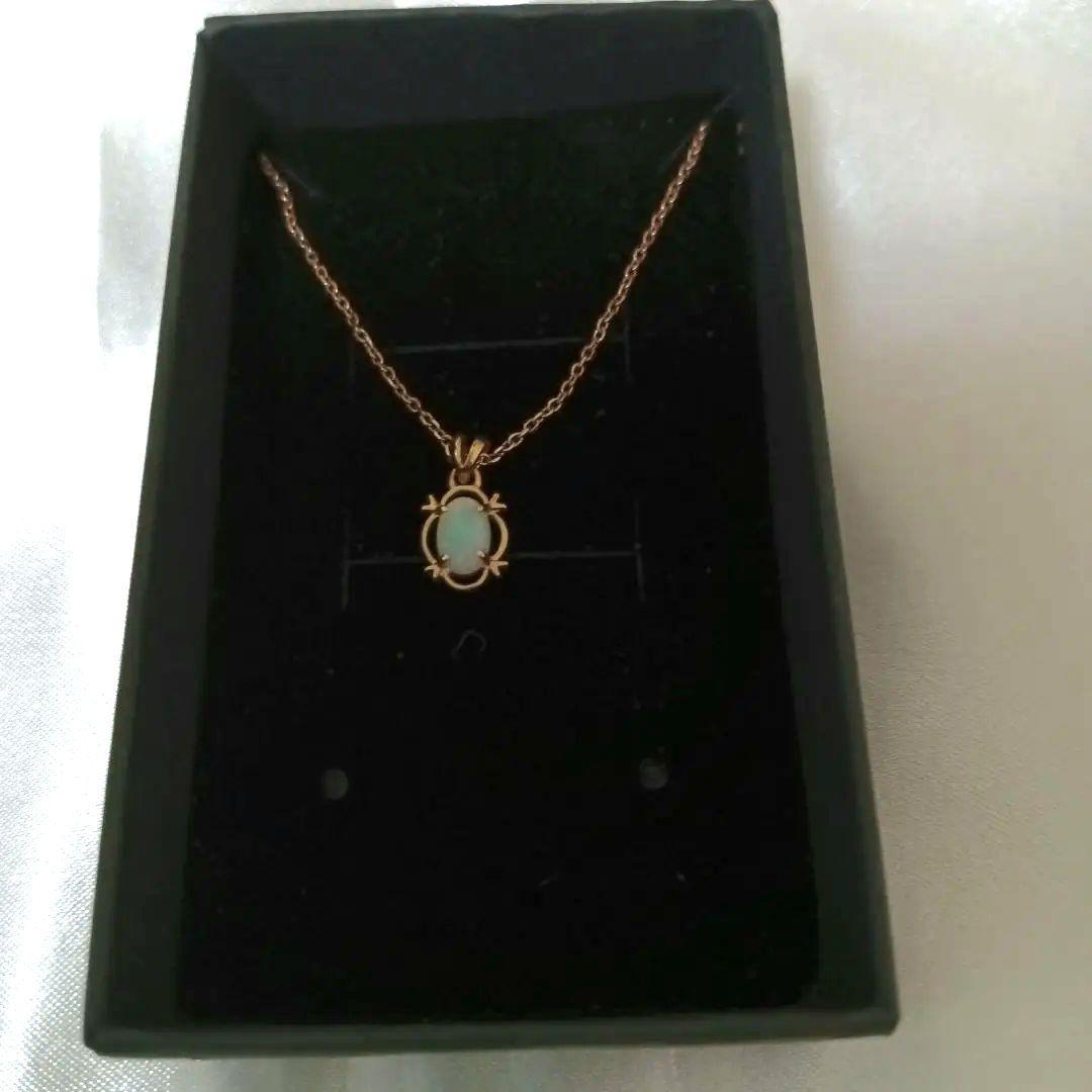 Ago oval-shaped opaque opal pendant gold necklace with pink, orange, and green colors on a rope chain