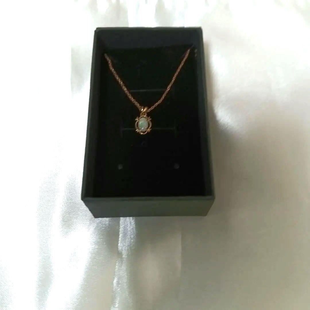 Ago oval-shaped opaque opal pendant gold necklace with pink, orange, and green colors on a rope chain