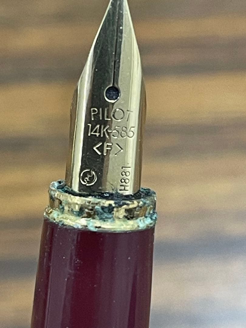 PILOT burgundy fountain pen with 14K gold fine nib displayed on white background