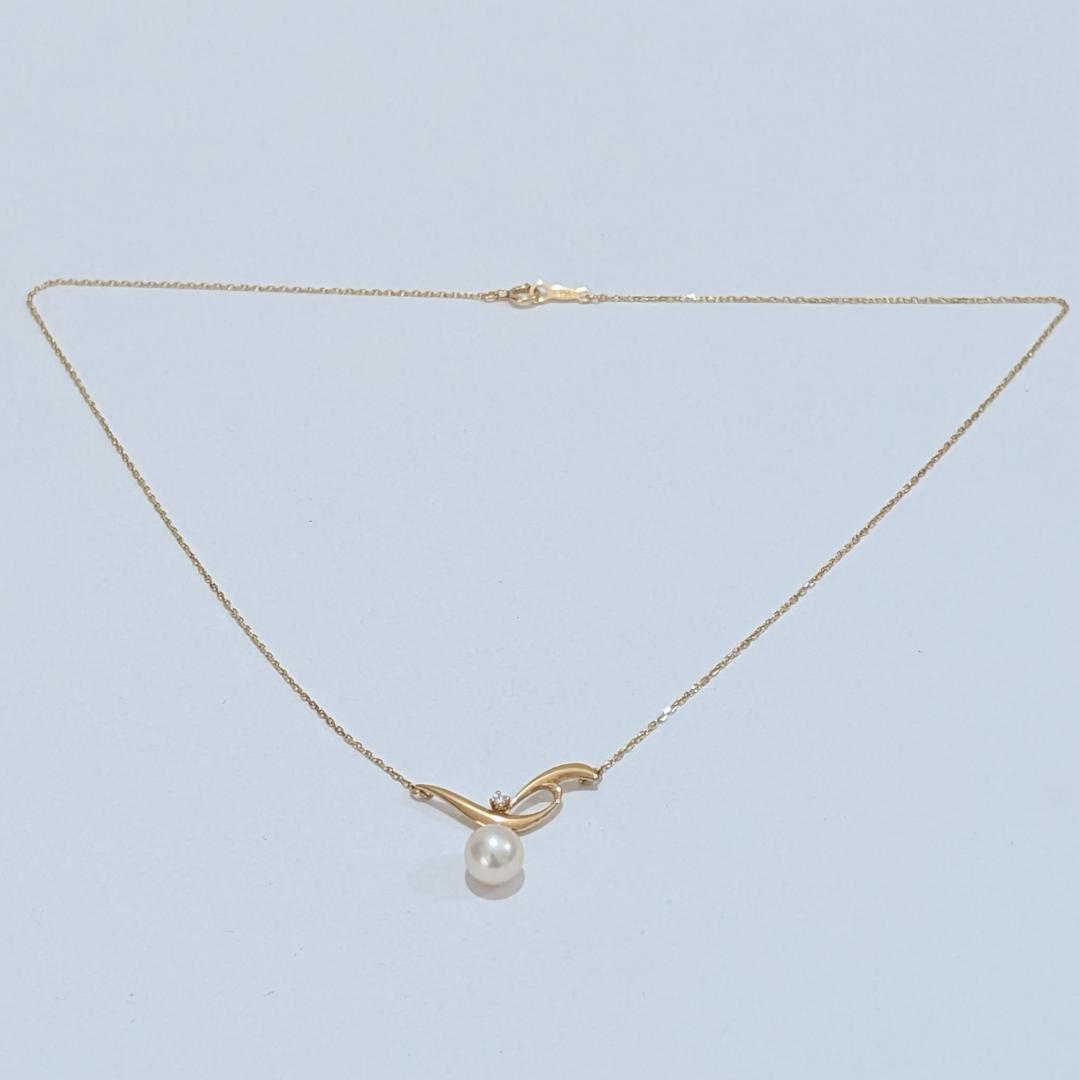 Mikimoto pearl necklace featuring a 7.3mm pearl and diamond set in 18K yellow gold with 42cm chain
