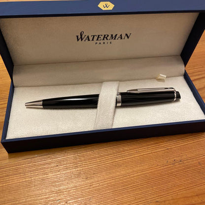 Waterman black metal ballpoint pen with replacement ink cartridges, approximately 14 cm long
