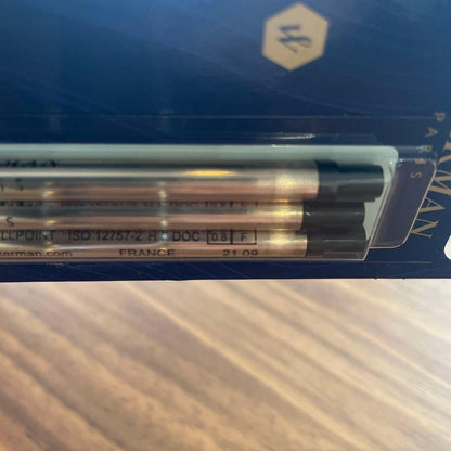 Waterman black metal ballpoint pen with replacement ink cartridges, approximately 14 cm long