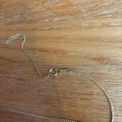 18K gold Akoya pearl necklace featuring a simple gold tone chain with no decorations or accessories
