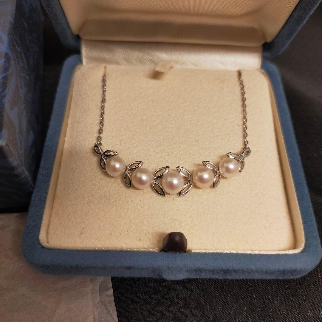 MIKIMOTO 5-row pearl necklace with leaf motif silver design featuring five pearls displayed on white background