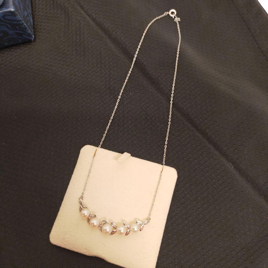 MIKIMOTO 5-row pearl necklace with leaf motif silver design featuring five pearls displayed on white background