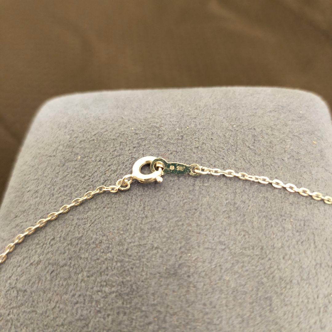 MIKIMOTO 5-row pearl necklace with leaf motif silver design featuring five pearls displayed on white background