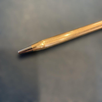 Kuro Cross Classic Century ballpoint pen with gold filled cap and barrel showing block letter logo