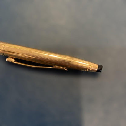 Kuro Cross Classic Century ballpoint pen with gold filled cap and barrel showing block letter logo