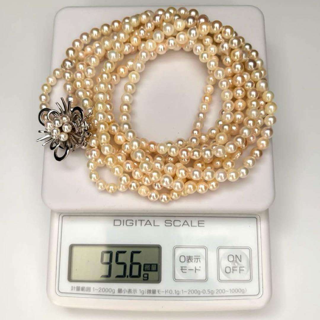 Long Akoya pearl necklace with 4-6mm white pearls measuring 198cm featuring multiple strands and silver marks