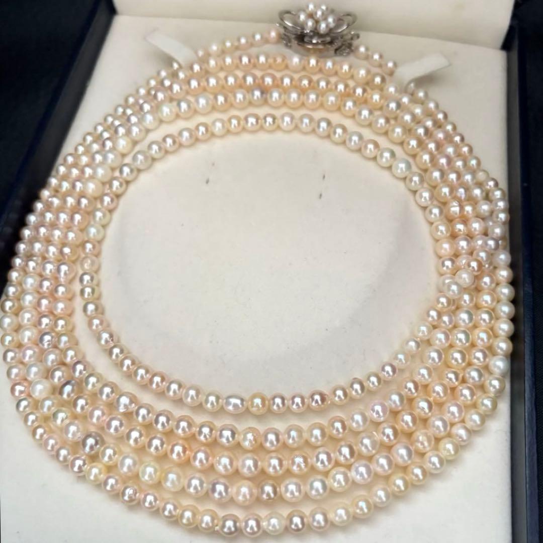 Long Akoya pearl necklace with 4-6mm white pearls measuring 198cm featuring multiple strands and silver marks