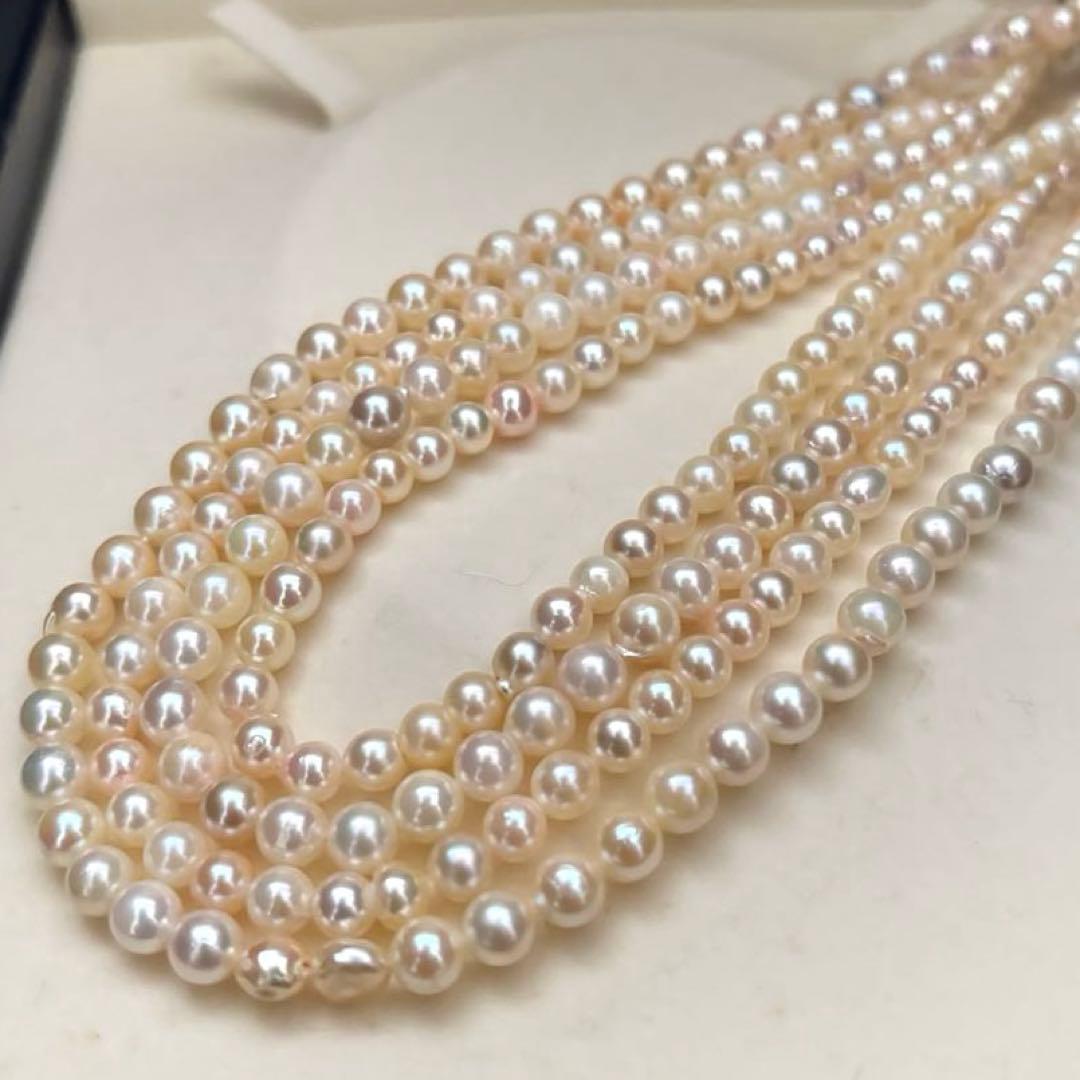 Long Akoya pearl necklace with 4-6mm white pearls measuring 198cm featuring multiple strands and silver marks