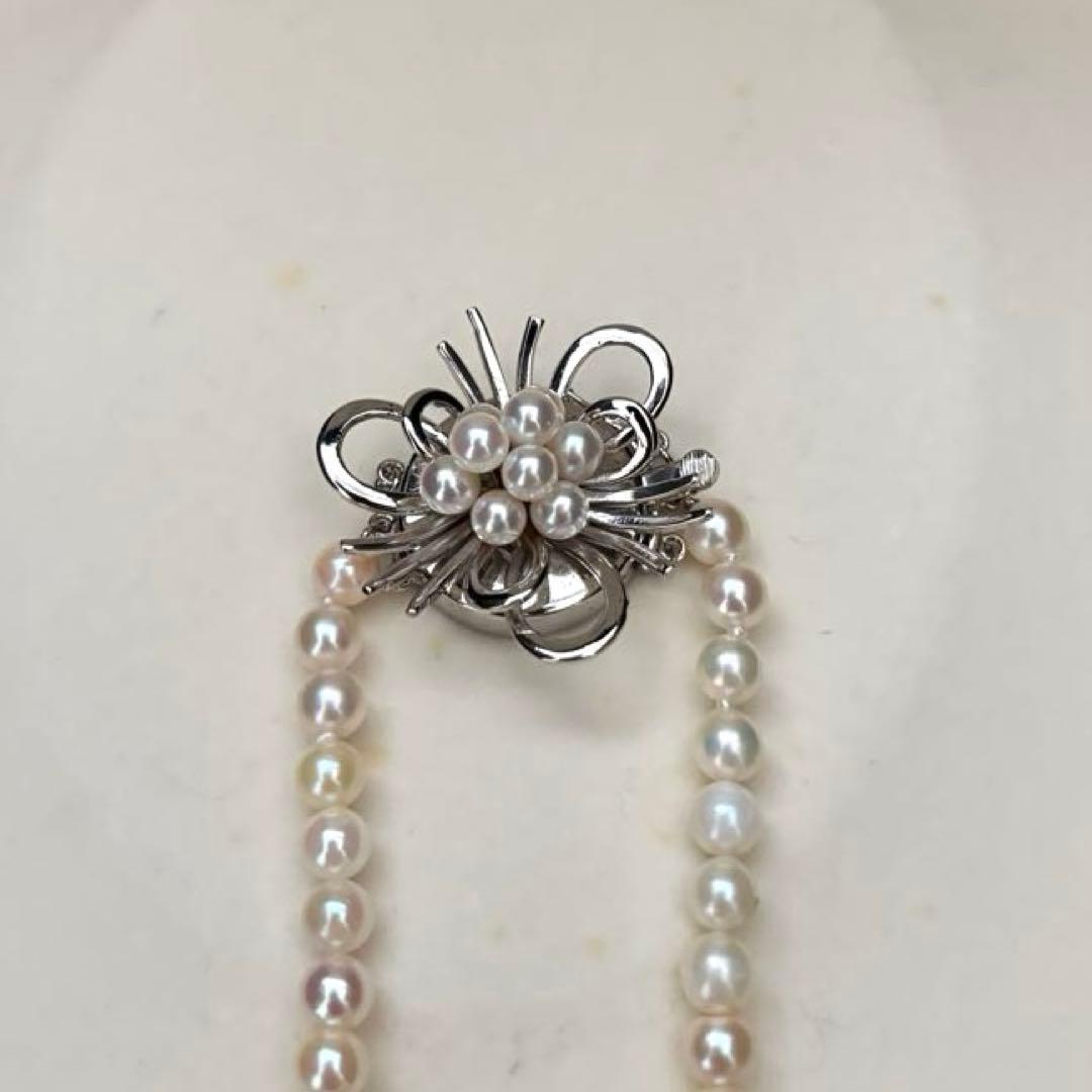 Long Akoya pearl necklace with 4-6mm white pearls measuring 198cm featuring multiple strands and silver marks