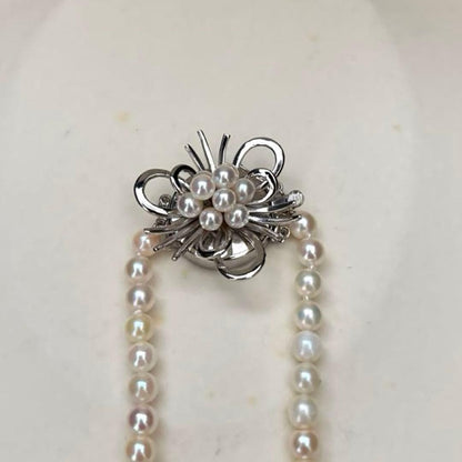Long Akoya pearl necklace with 4-6mm white pearls measuring 198cm featuring multiple strands and silver marks