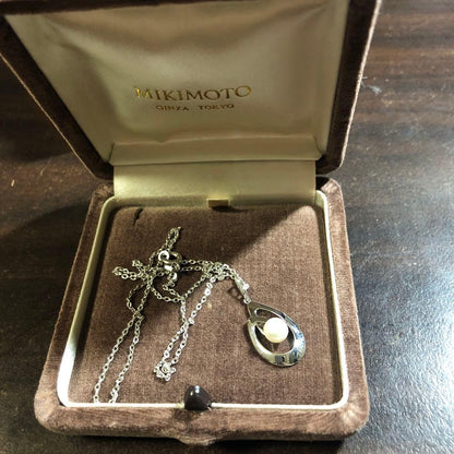 12330MIKIMOTO pearl necklace with 5.8mm pearls in silver displayed with dedicated case