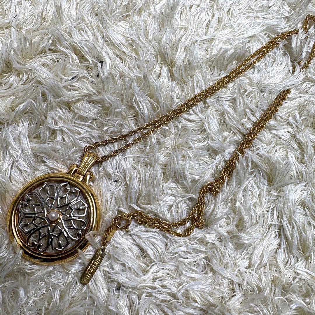 Mikimoto single pearl necklace with loupe showing pristine used condition and elegant design