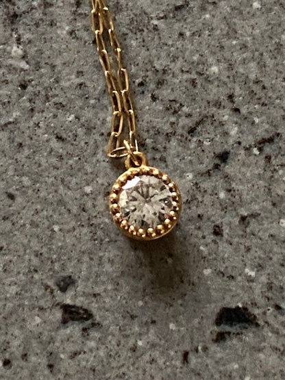Agete K18 gold necklace featuring a 0.15-carat single diamond with milgrain detail on a 45cm slide chain