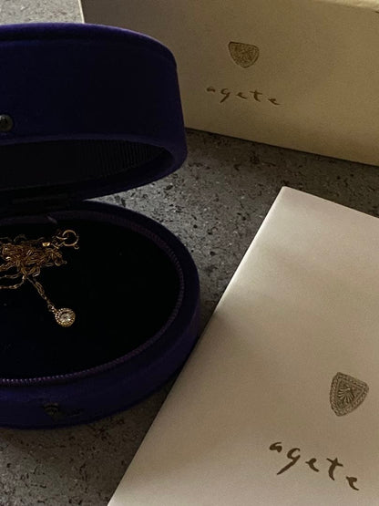 Agete K18 gold necklace featuring a 0.15-carat single diamond with milgrain detail on a 45cm slide chain