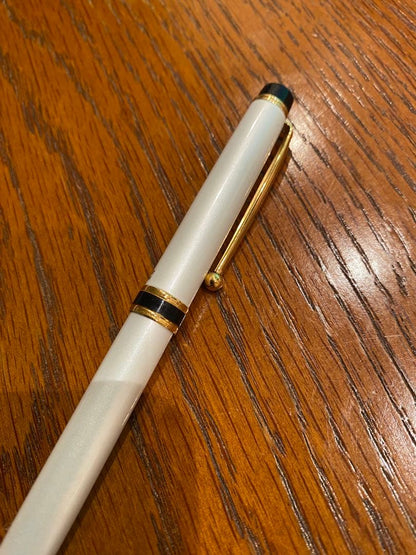 Pilot ballpoint pen with white metal body, gold trim, and blue top shown on a white background
