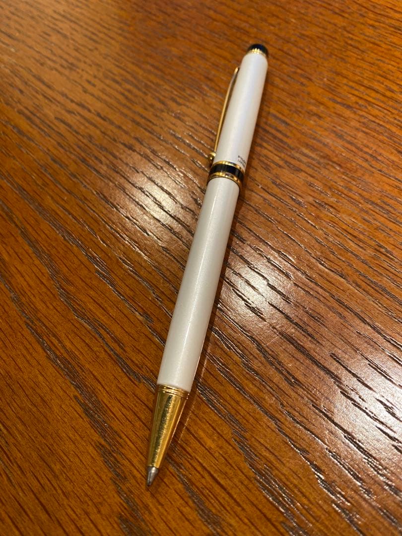 Pilot ballpoint pen with white metal body, gold trim, and blue top shown on a white background