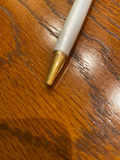 Pilot ballpoint pen with white metal body, gold trim, and blue top shown on a white background