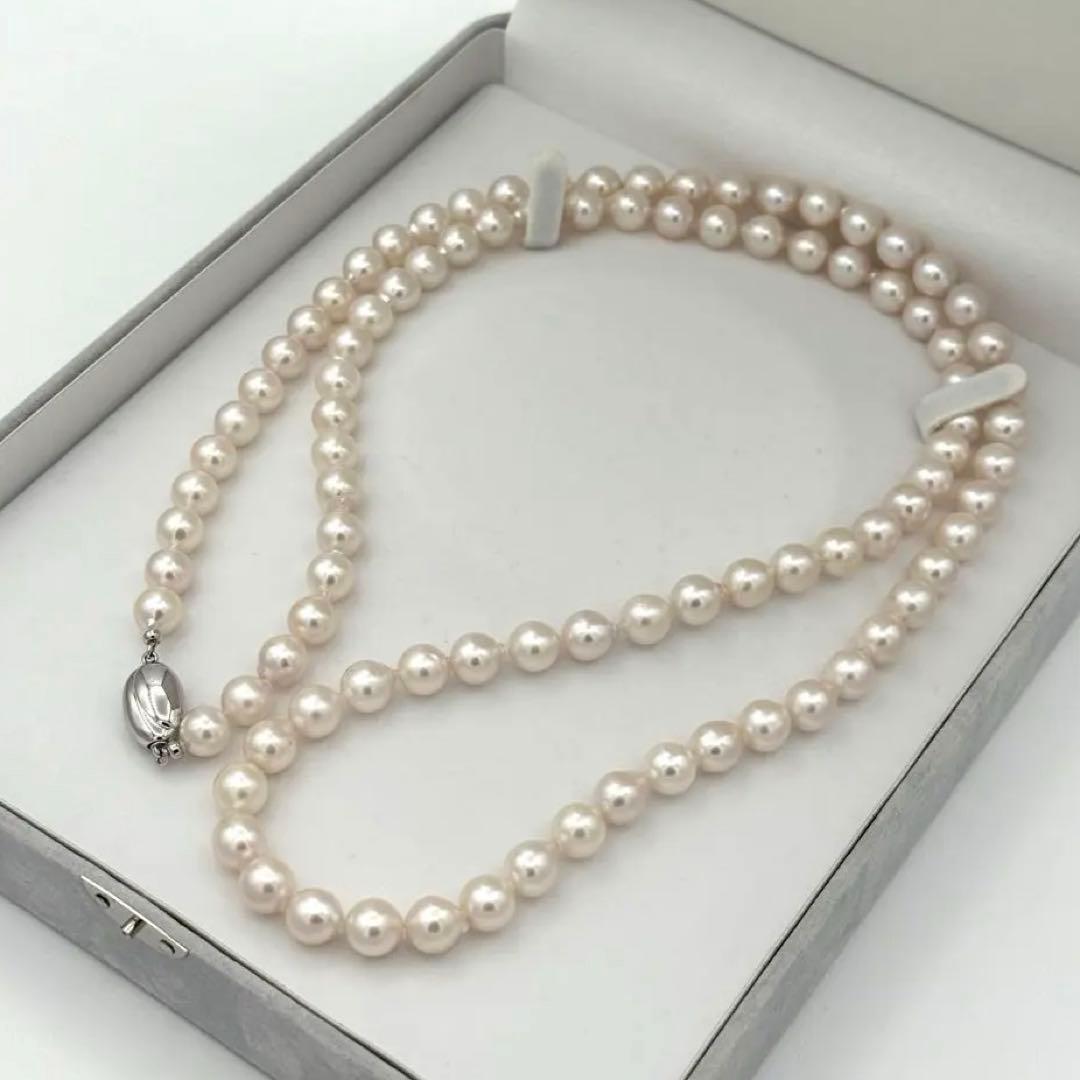 Akoya pearl necklace with 8.0mm-8.5mm pearls, 80cm length, white lustrous pearls on a display