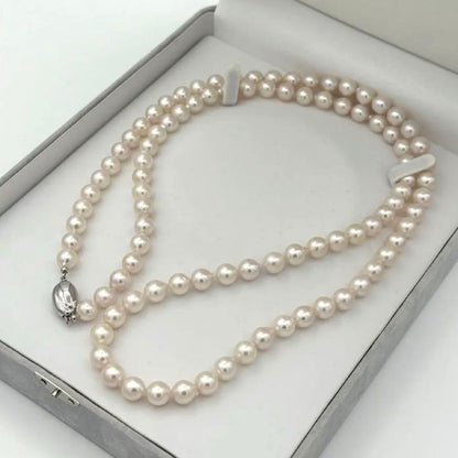 Akoya pearl necklace with 8.0mm-8.5mm pearls, 80cm length, white lustrous pearls on a display