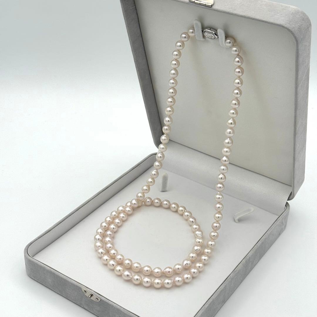 Akoya pearl necklace with 8.0mm-8.5mm pearls, 80cm length, white lustrous pearls on a display