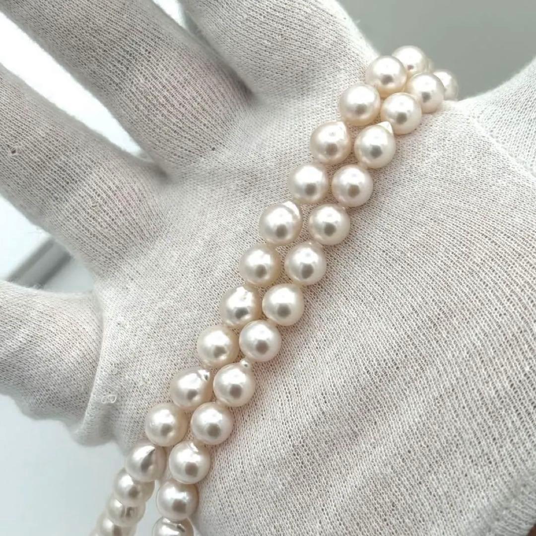 Akoya pearl necklace with 8.0mm-8.5mm pearls, 80cm length, white lustrous pearls on a display
