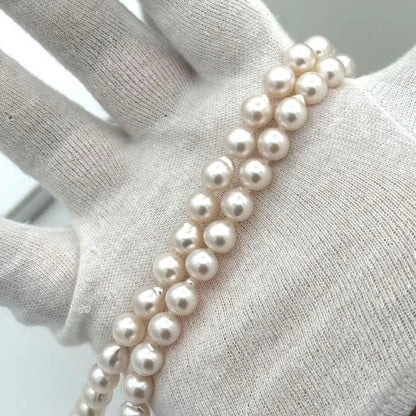 Akoya pearl necklace with 8.0mm-8.5mm pearls, 80cm length, white lustrous pearls on a display