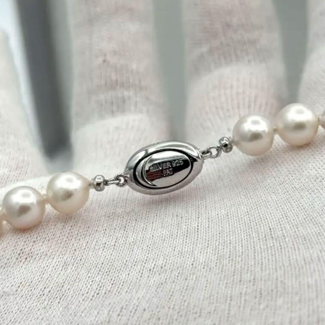 Akoya pearl necklace with 8.0mm-8.5mm pearls, 80cm length, white lustrous pearls on a display