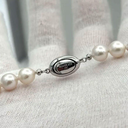 Akoya pearl necklace with 8.0mm-8.5mm pearls, 80cm length, white lustrous pearls on a display