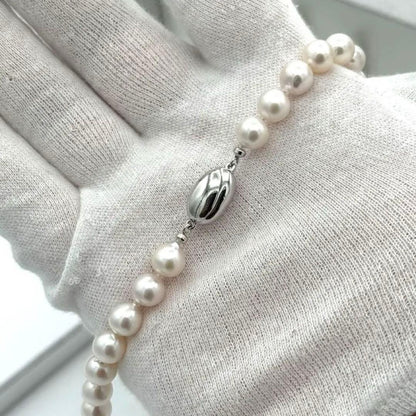 Akoya pearl necklace with 8.0mm-8.5mm pearls, 80cm length, white lustrous pearls on a display
