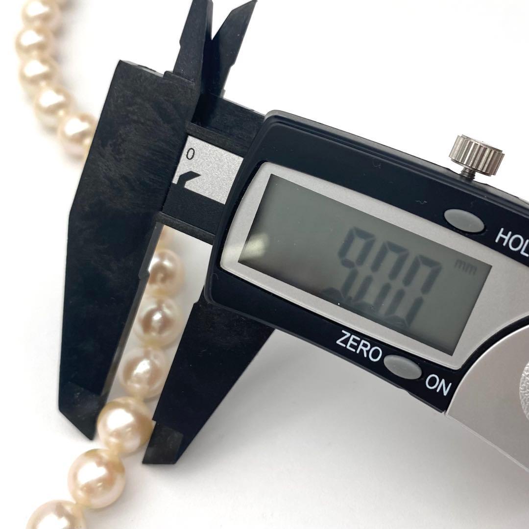 White Akoya pearl necklace and matching earrings with 8.5-9mm round pearls displayed on a white background