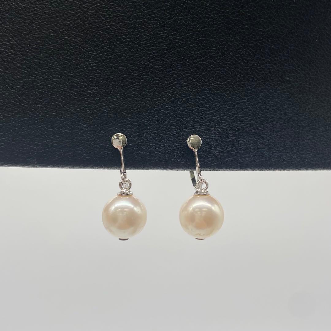 White Akoya pearl necklace and matching earrings with 8.5-9mm round pearls displayed on a white background