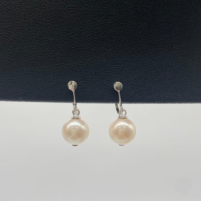 White Akoya pearl necklace and matching earrings with 8.5-9mm round pearls displayed on a white background