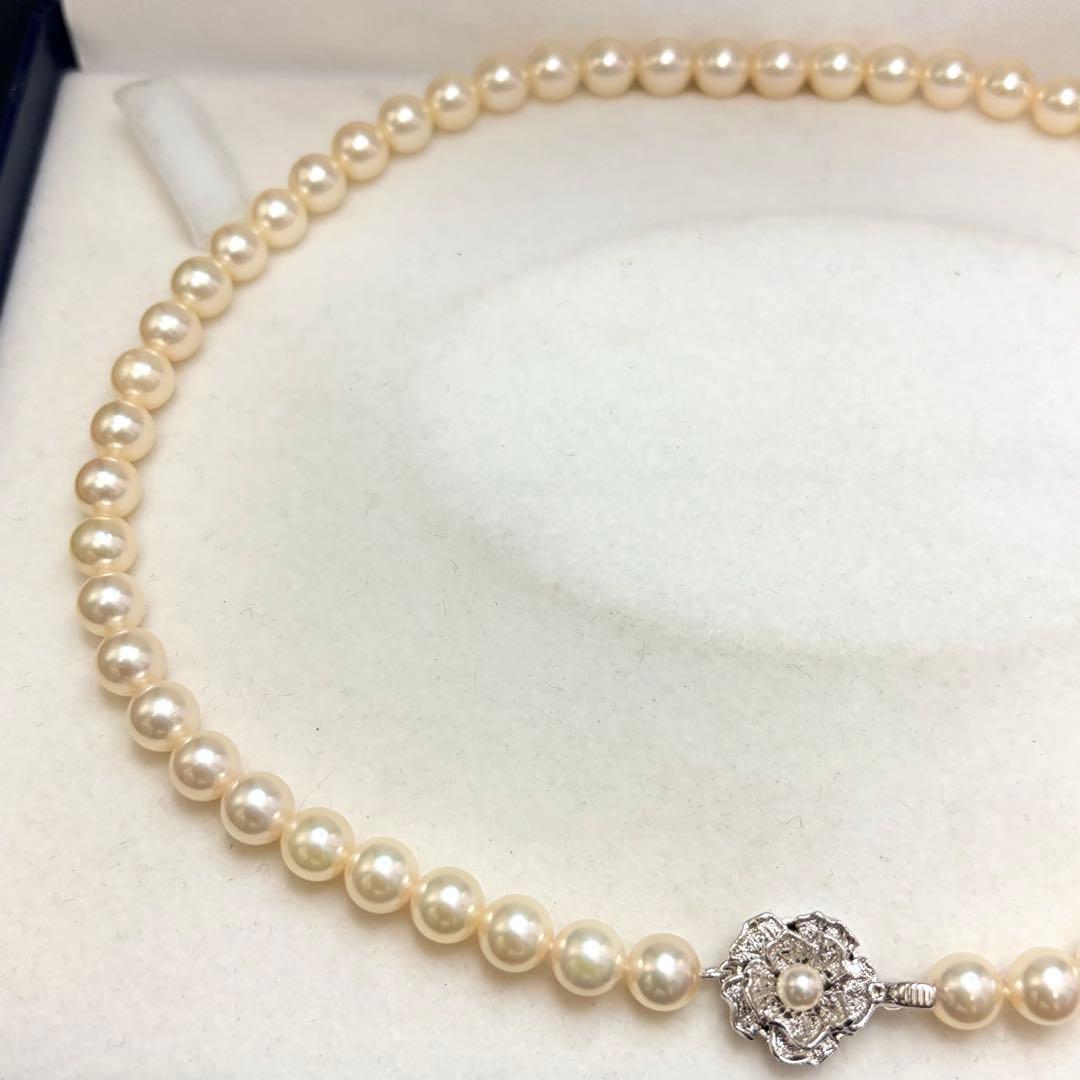 Akoya pearl necklace with 7.24mm white pearls and silver clasp on a white background