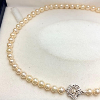 Akoya pearl necklace with 7.24mm white pearls and silver clasp on a white background