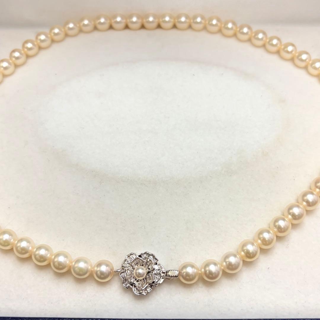 Akoya pearl necklace with 7.24mm white pearls and silver clasp on a white background