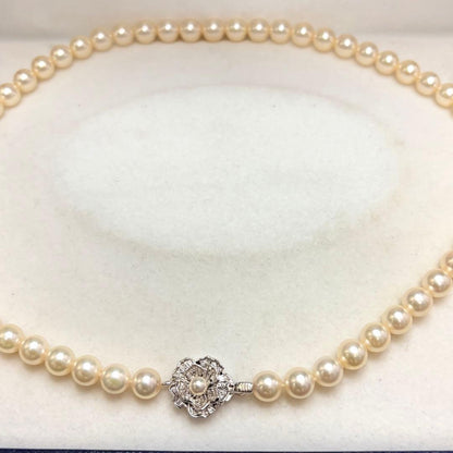 Akoya pearl necklace with 7.24mm white pearls and silver clasp on a white background
